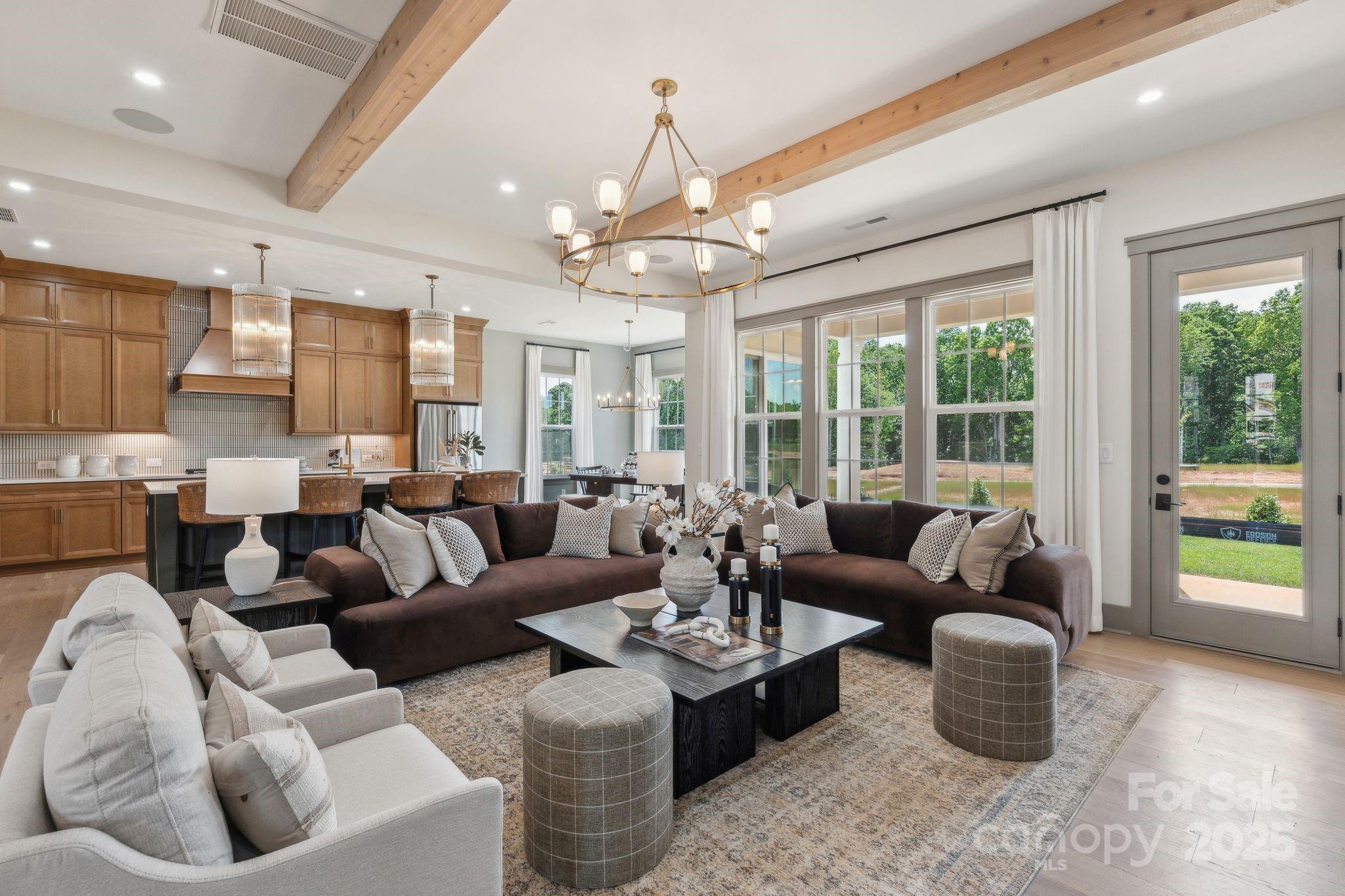 13648 Glennmayes Road Huntersville, NC 28078 - Photo 2 of 32 a living room with furniture and a chandelier