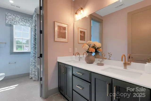 a bathroom with a sink double vanity and a mirror