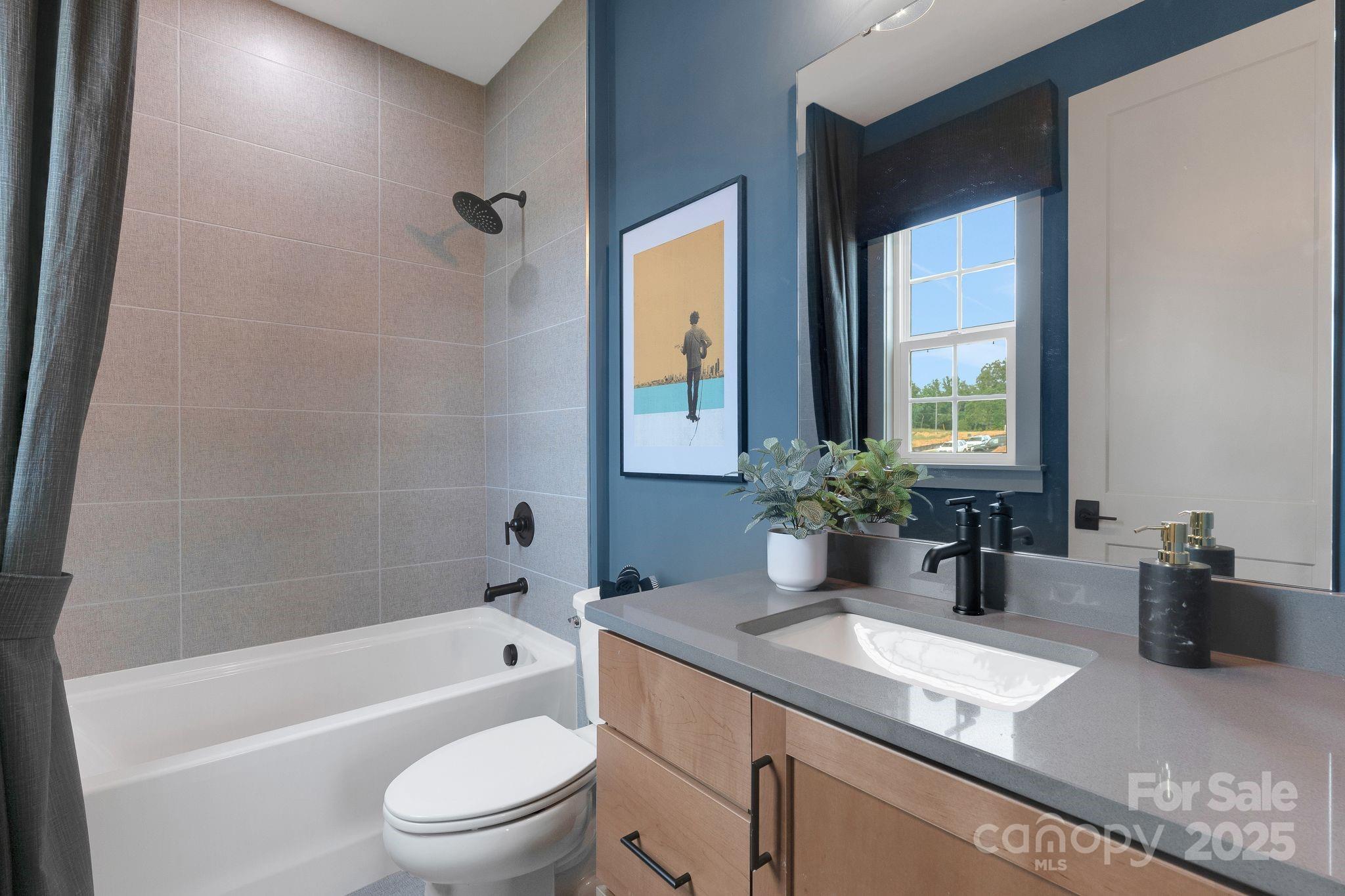 13648 Glennmayes Road Huntersville, NC 28078 - Photo 27 of 32 a bathroom with a granite countertop sink a toilet and shower