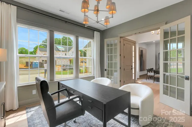 a view of a dining room with furniture large windows and wooden floor