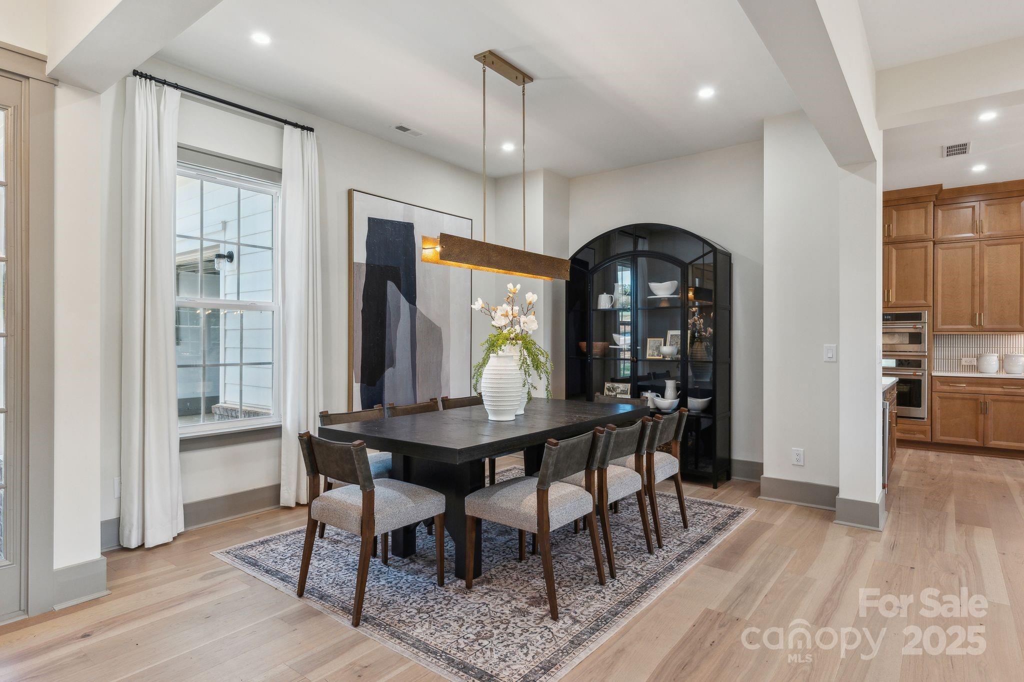13648 Glennmayes Road Huntersville, NC 28078 - Photo 6 of 32 a view of a dining room with furniture window and wooden floor
