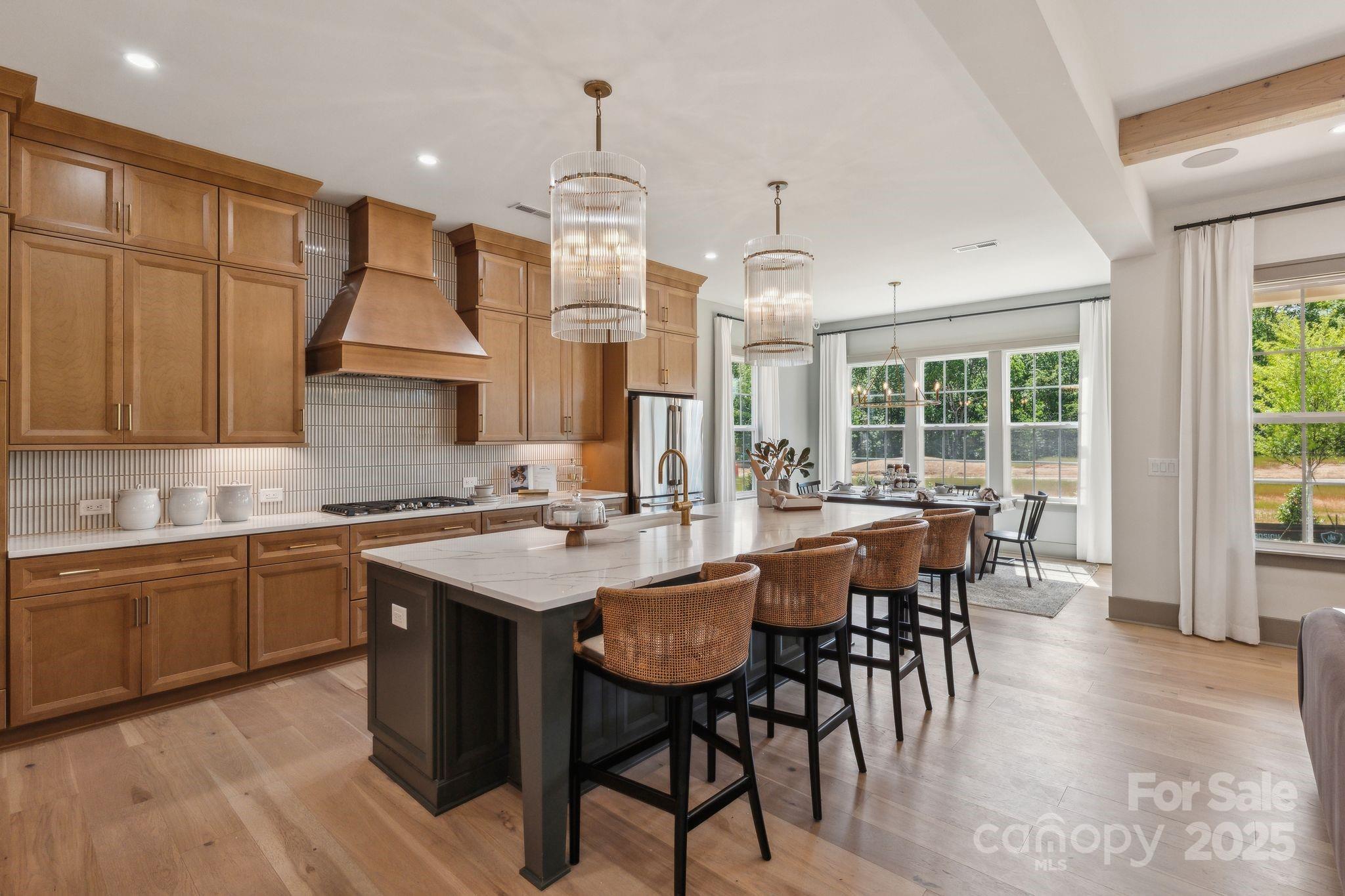 13648 Glennmayes Road Huntersville, NC 28078 - Photo 7 of 32 a kitchen with center island table and chairs in it