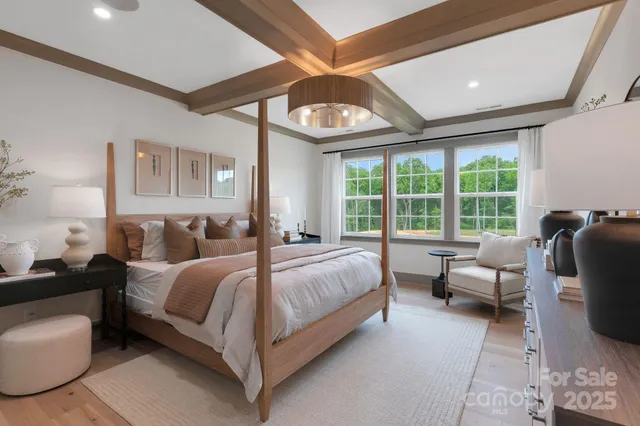 a bed room with a bed couch and a large window