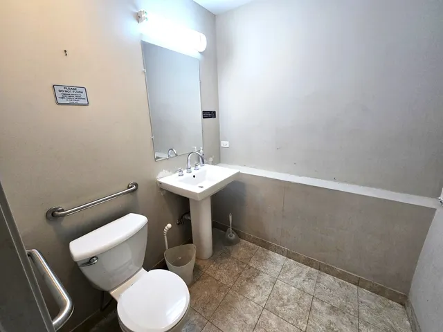 a bathroom with a sink toilet and a mirror