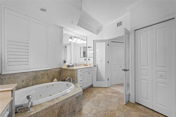 a bathroom with a tub sink and mirror