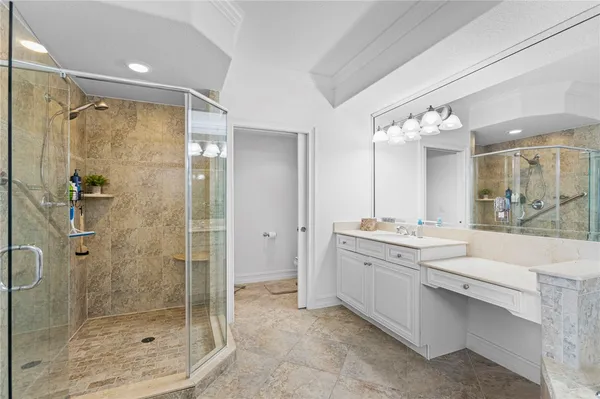 a bathroom with a granite countertop sink mirror and shower