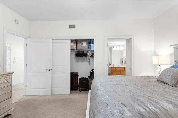 a bedroom with a bed and a television
