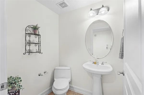a bathroom with a sink toilet and mirror