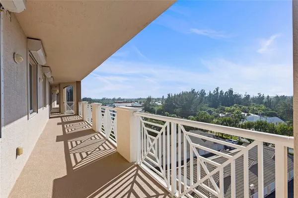 a view of a balcony with wooden floor and fence