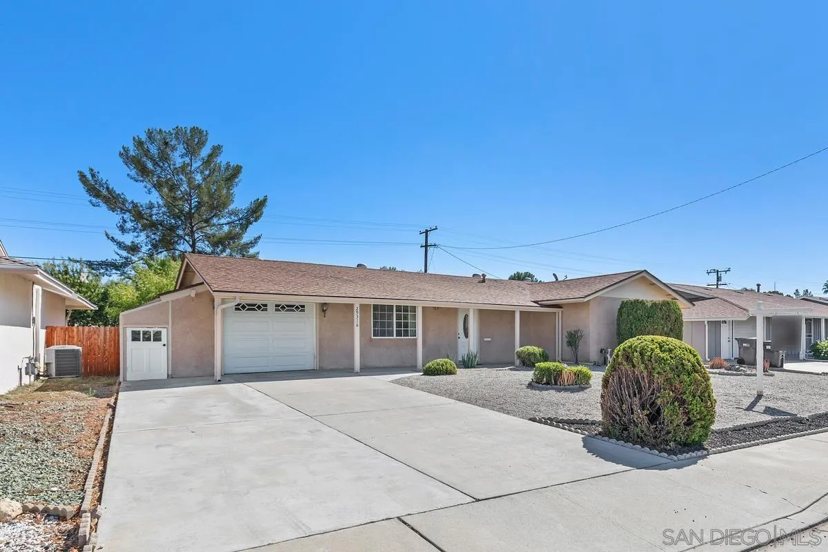 29316 Carmel Road Menifee, CA 92586 - Photo 2 of 3 a front view of a house with a garden and garage