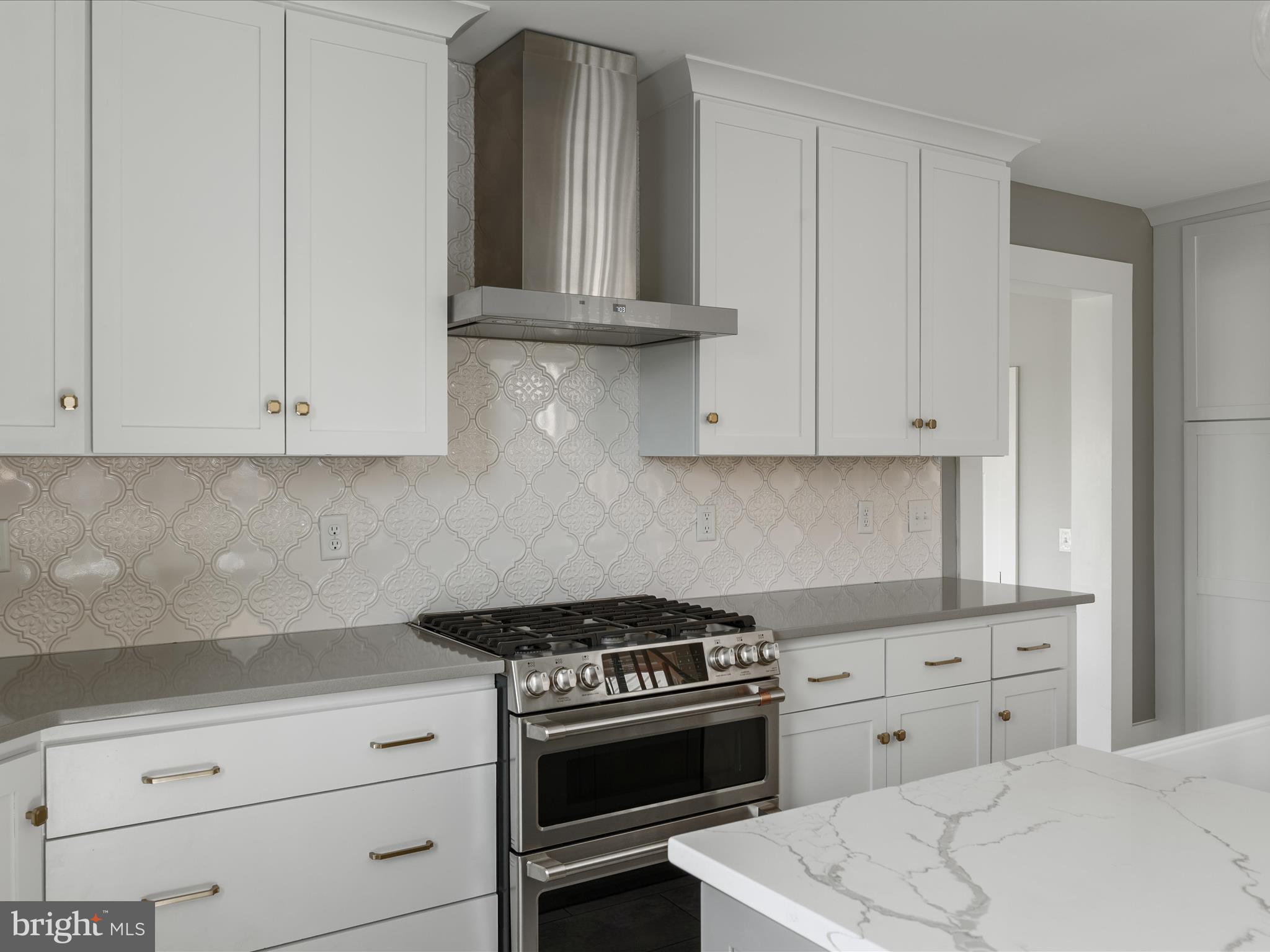 7919 Church Street Middletown, VA 22645 - Photo 10 of 48 a kitchen with granite countertop white cabinets and white appliances