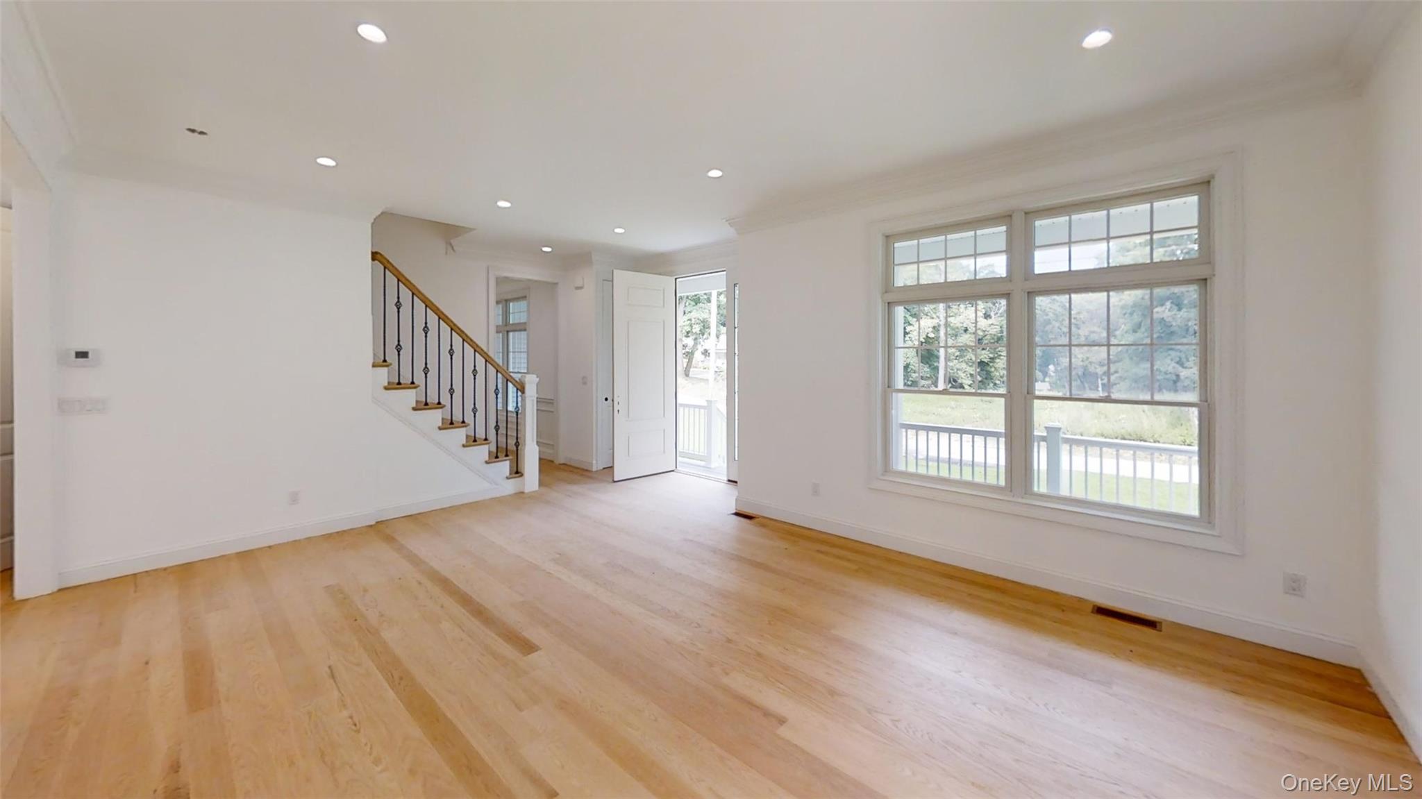 10 Winfield Drive Sound Beach, NY 11789 - Photo 6 of 11 a view of an empty room with wooden floor and a window