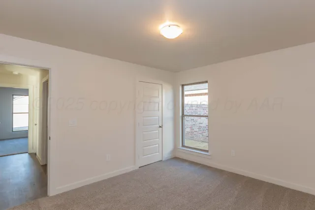 an empty room with windows and closet