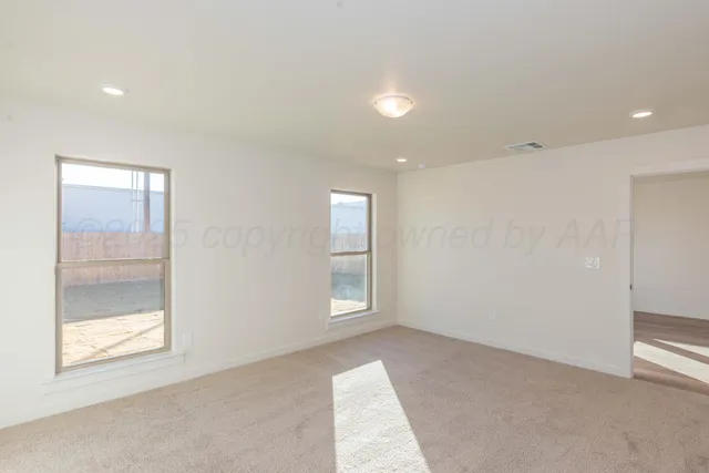 an empty room with windows and closet