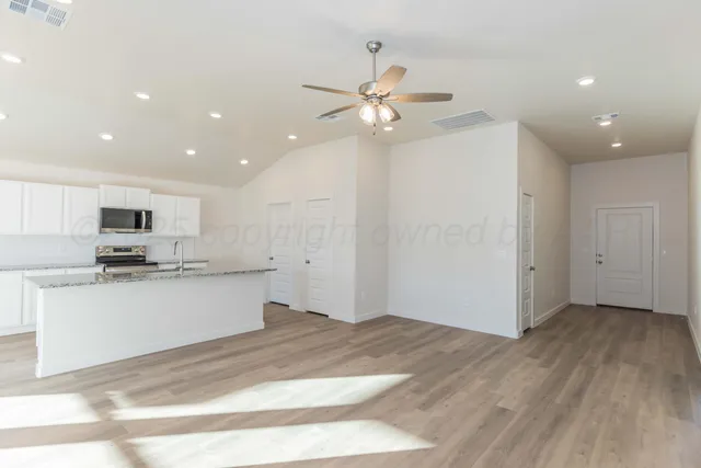 a view of kitchen with sink microwave and stove