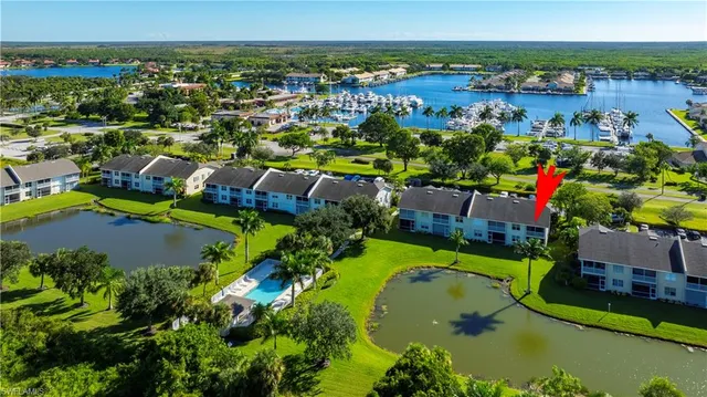 an aerial view of a house with a swimming pool outdoor seating and yard