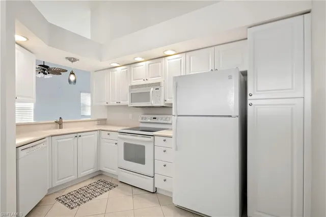 a white refrigerator freezer sitting inside of a kitchen