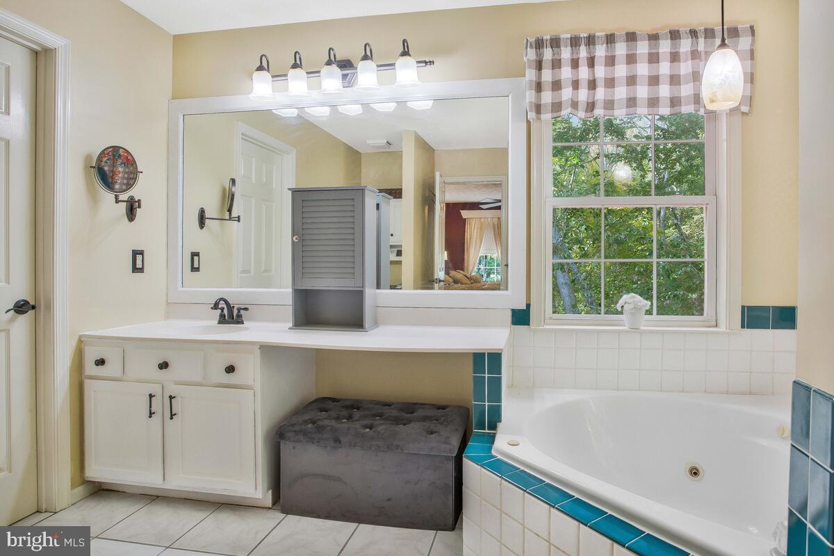 165 Ball Road St. Leonard, MD 20685 - Photo 38 of 55 a bathroom with a tub sink and mirror