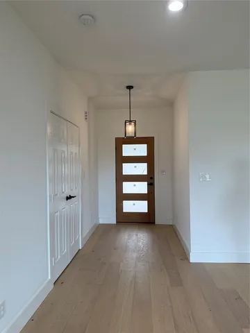 a view of room with wooden floor and windows