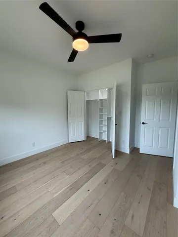 a view of an empty room and wooden floor