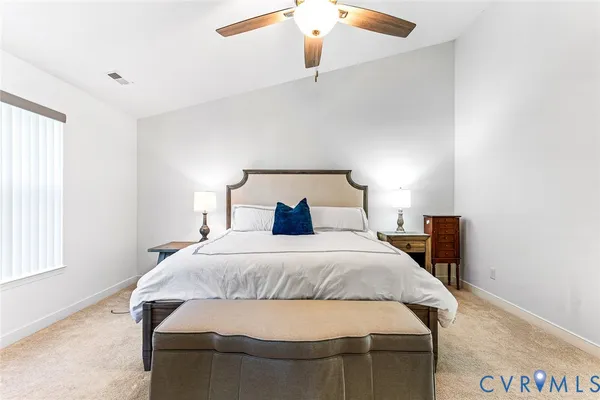 a bedroom with a bed and window