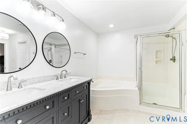 a bathroom with a sink a mirror a bathtub and shower