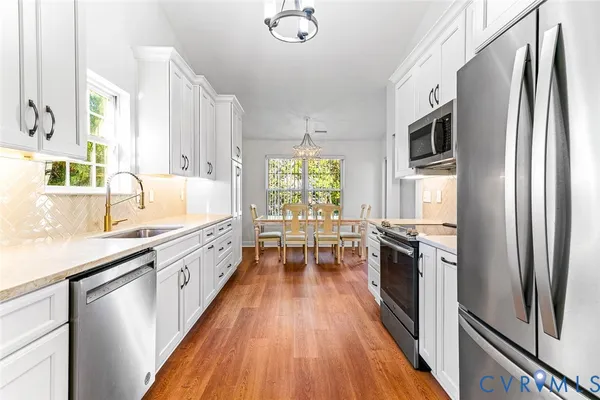 a kitchen with stainless steel appliances a stove sink and refrigerator
