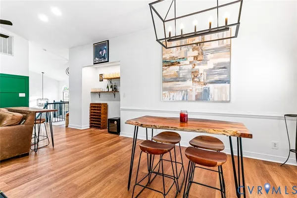 a dining room with furniture and wooden floor