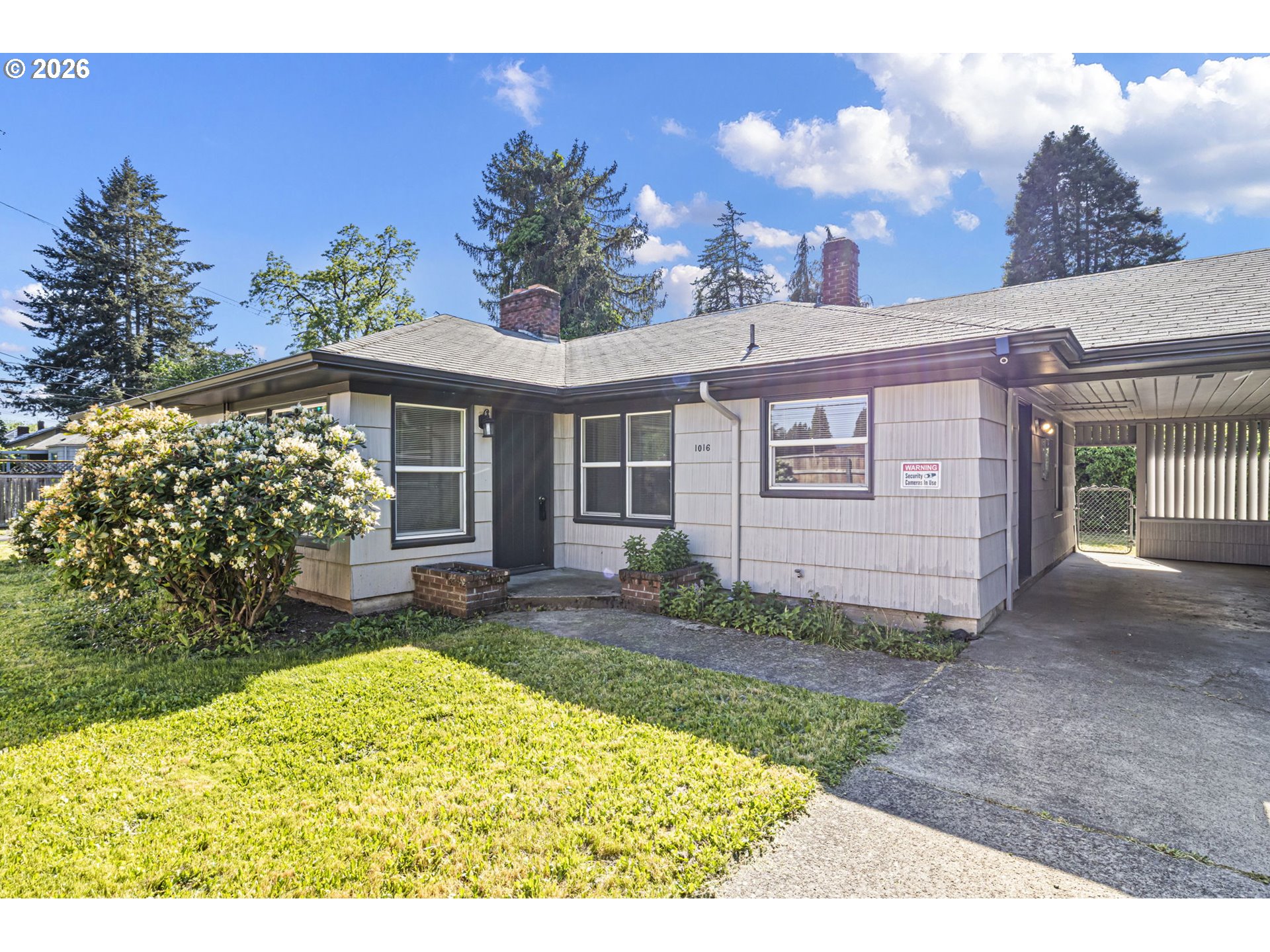 1008 Coburg Road Eugene, OR 97401 - Photo 29 of 46 a view of a house with a small yard and potted plants