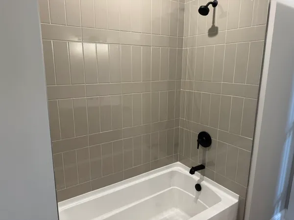 a bath tub sitting next to a shower