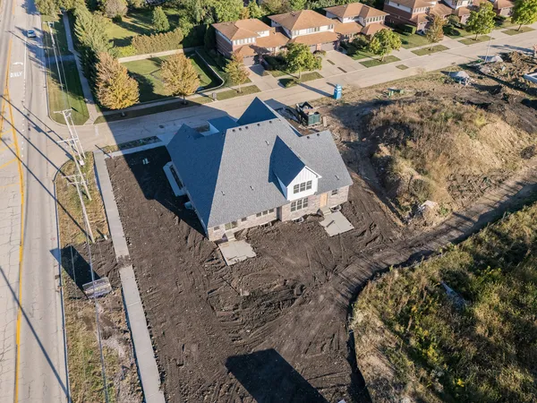 an aerial view of a house with a yard
