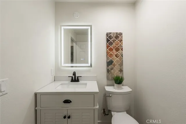 a bathroom with a sink a toilet and shower curtain