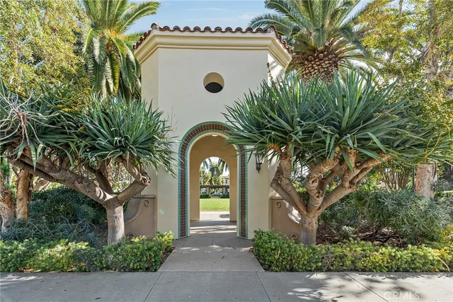 a view of a house with a tree and plants