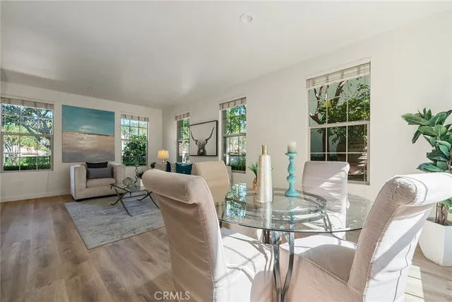 a dining room with furniture a livingroom view and windows