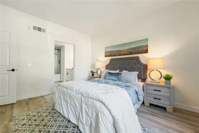 a bedroom with a bed and wooden floor