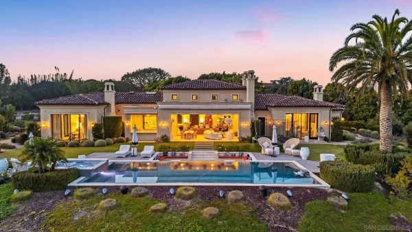 a view of a swimming pool with outdoor seating