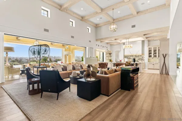 a living room with lots of furniture and a large window