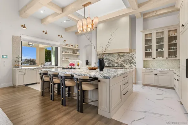 a kitchen with stainless steel appliances kitchen island granite countertop a sink and cabinets