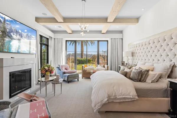 a spacious bedroom with a balcony a bed and a fireplace