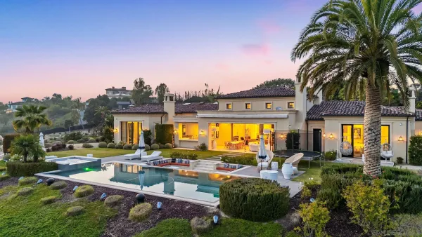a view of a house with swimming pool and sitting area