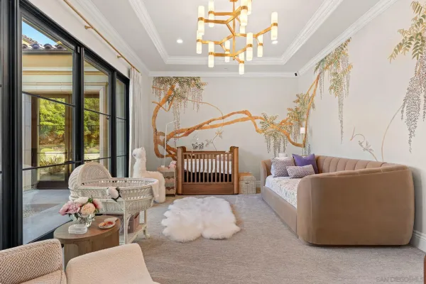 a living room with furniture chandelier and a large window