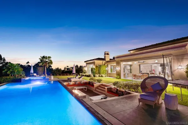 a view of a swimming pool with outdoor seating