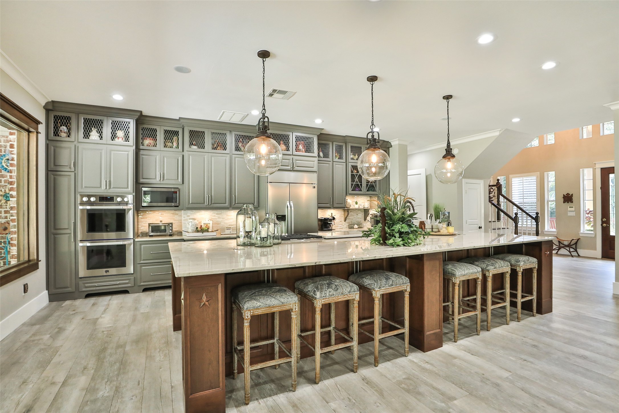 12126 Zion Road Tomball, TX 77375 - Photo 20 of 45 The kitchen is a chef's dream, boasting a stunning 15x7 island with Quartzite counters and custom solid wood cabinets. With ample storage and modern appliances, this culinary haven is sure to inspire your culinary creations.