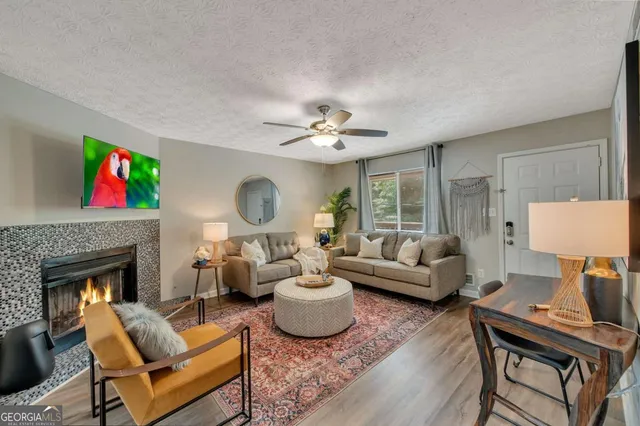 a living room with furniture a fireplace and a flat screen tv