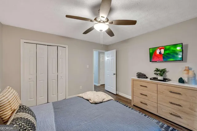 a bedroom with furniture and a flat screen tv