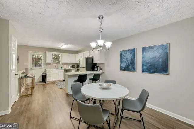 a view of a dining room with furniture and wooden floor