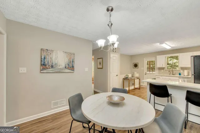 a view of a dining room with furniture and wooden floor