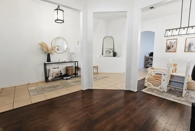a living room with furniture and wooden floor