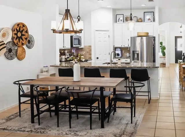 a kitchen with a sink dishwasher a stove and a fireplace with wooden floor