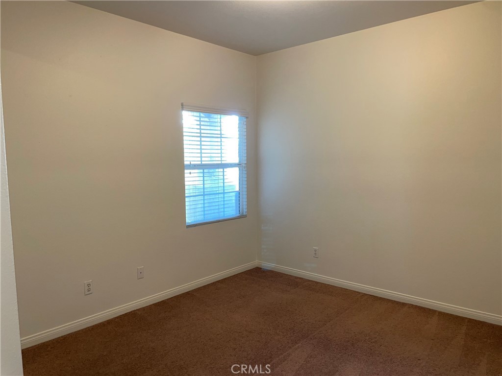 12661 Luna Road Victorville, CA 92392 - Photo 10 of 20 an empty room with a window
